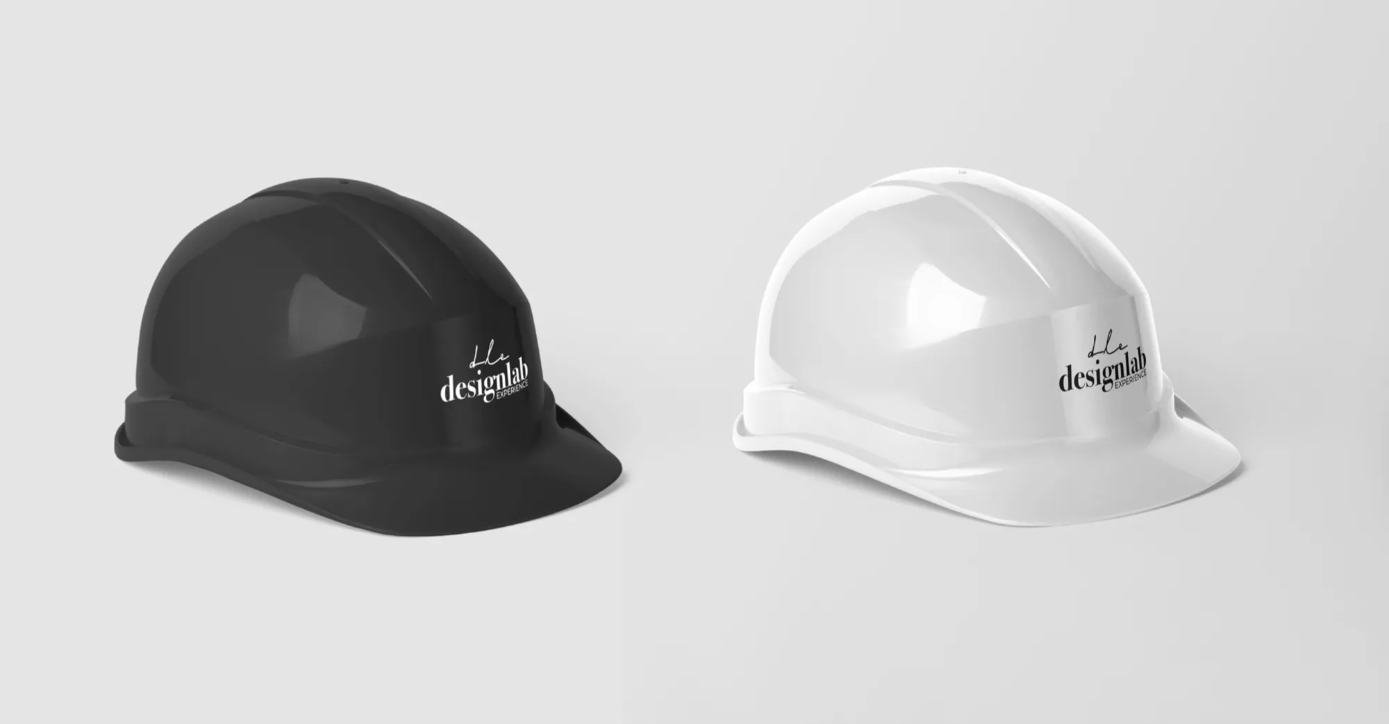 A black and a white hard hat, each with the logo