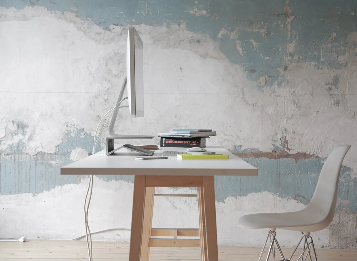 Stand in real life: an iMac on it, on a white desk in front of a peeling blue wall