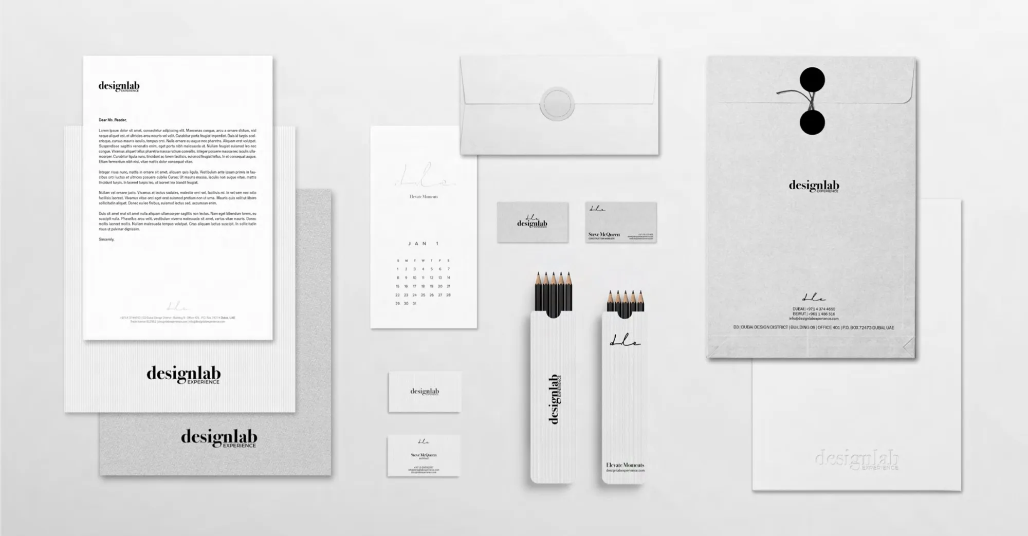 Letterhead, envelopes, cards, a calendar and pencils, all in white and grey